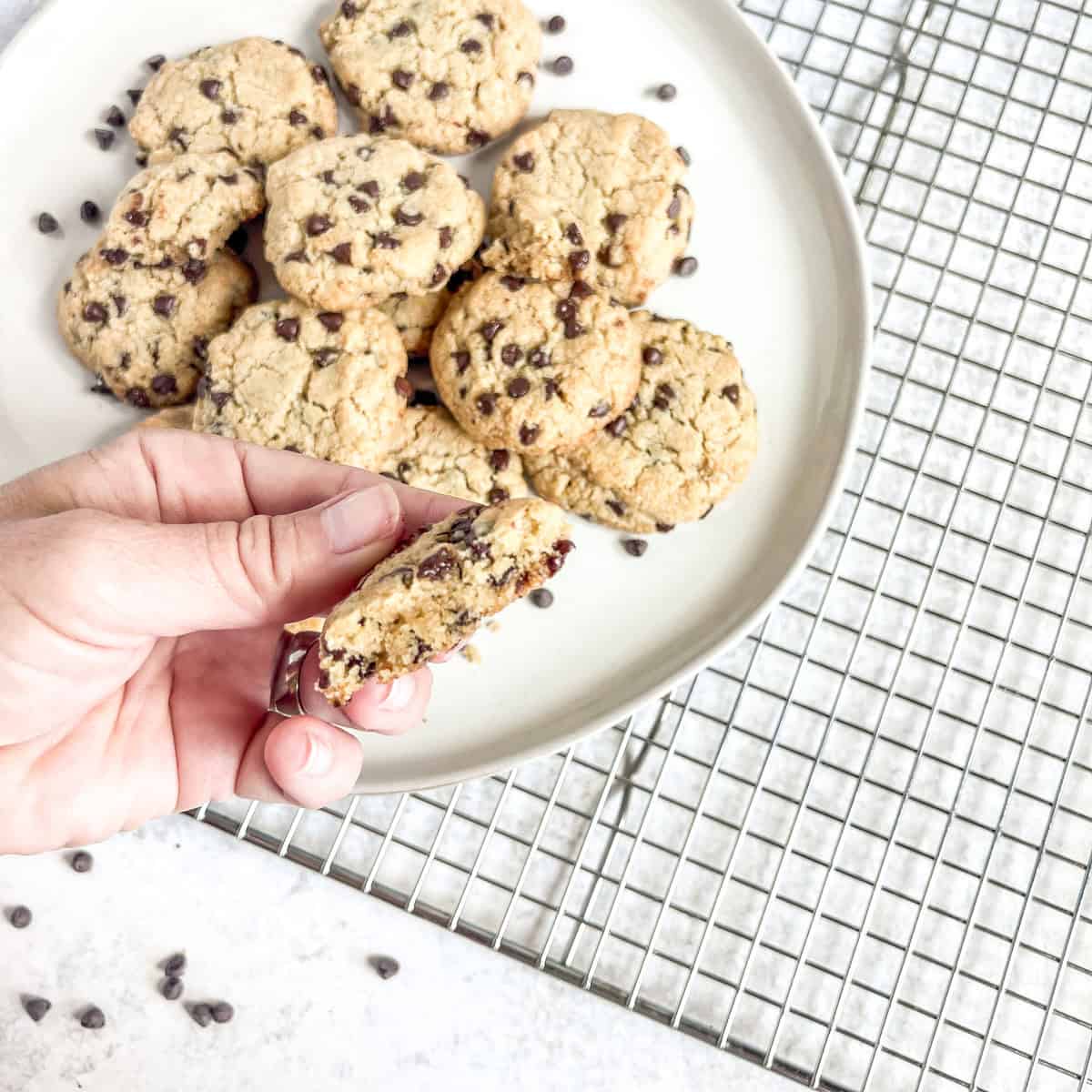 Almond Flour Chocolate Chip Cookies fingers holding half a cookie