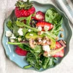 Strawberry Walnut Salad on a curvy blue plate