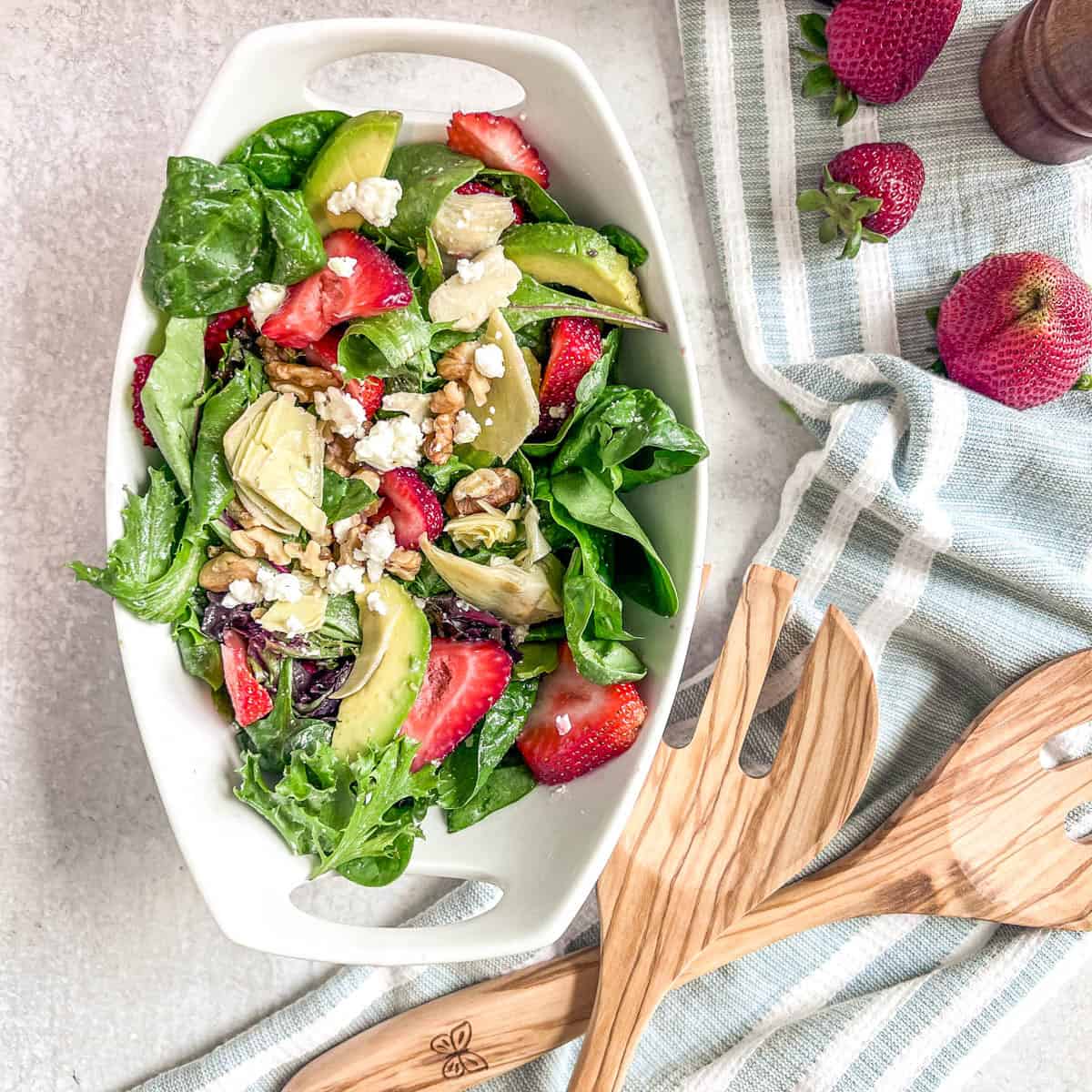 Strawberry Walnut Salad with strawberries, artichoke hearts, avocado, walnuts, and spring mix
