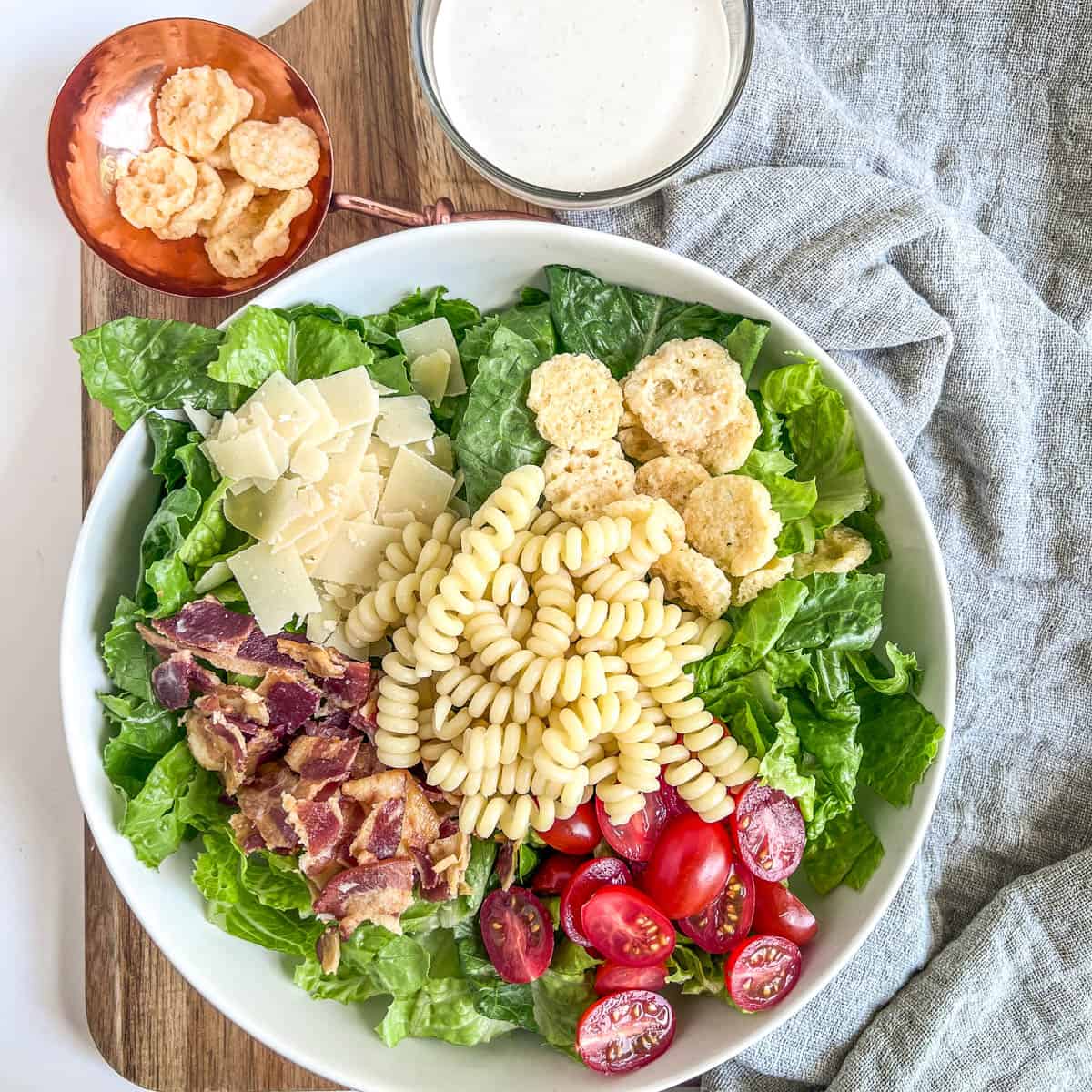 caesar pasta salad ingredients in a bowl