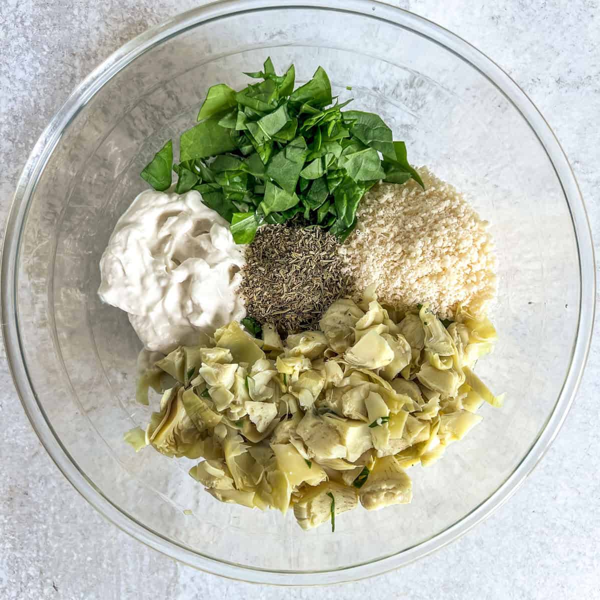 Hot spinach dip ingredients in a glass bowl