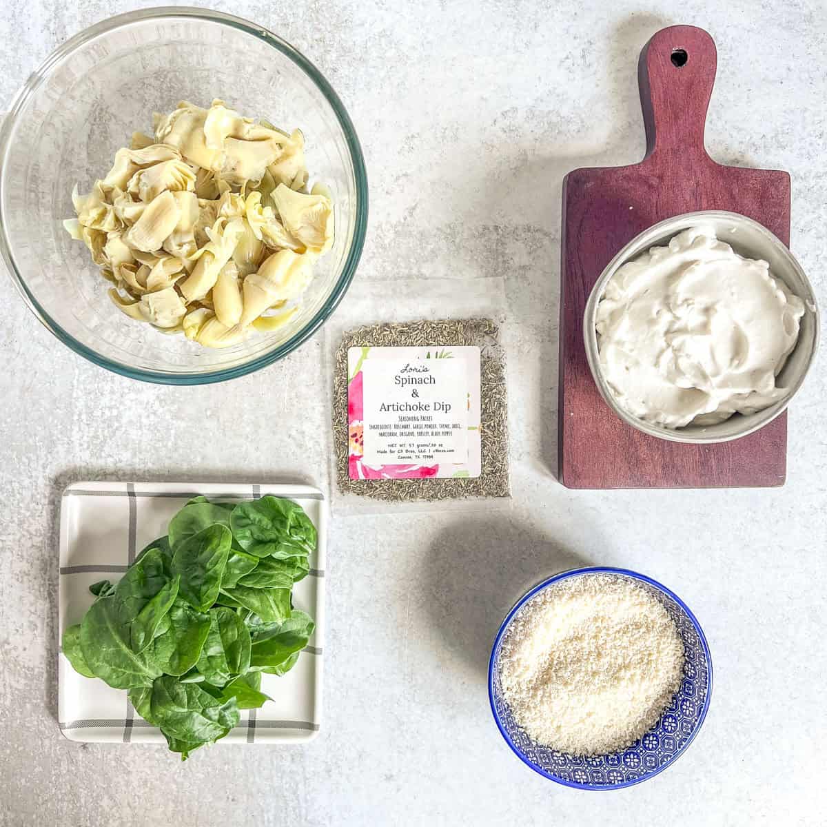 Hot spinach dip ingredients in bowls and a plate