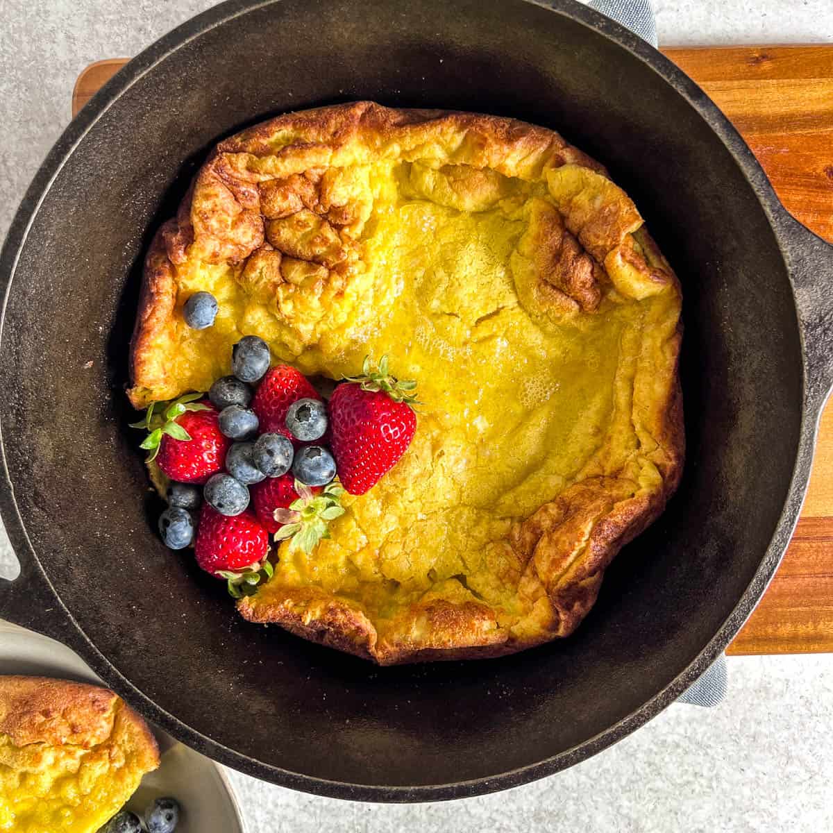simple dutch baby recipe baked with berries