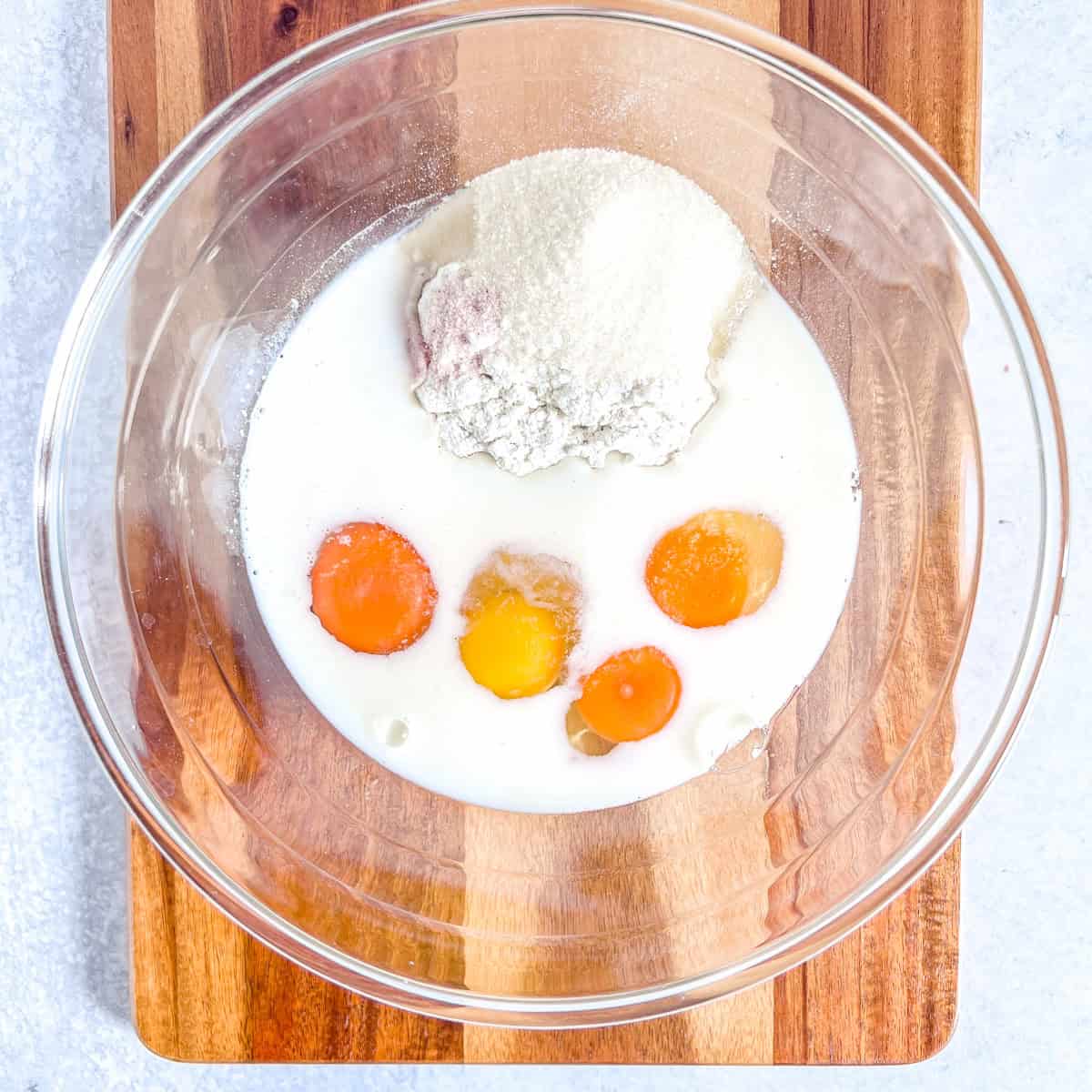 simple dutch baby recipe ingredients in a glass bowl