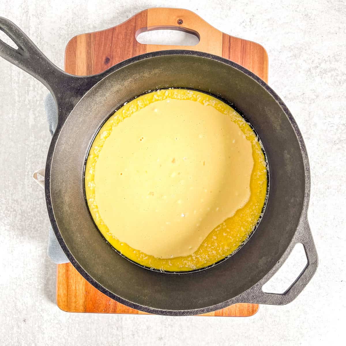 simple dutch baby ingredients mixed together in a cast iron skillet