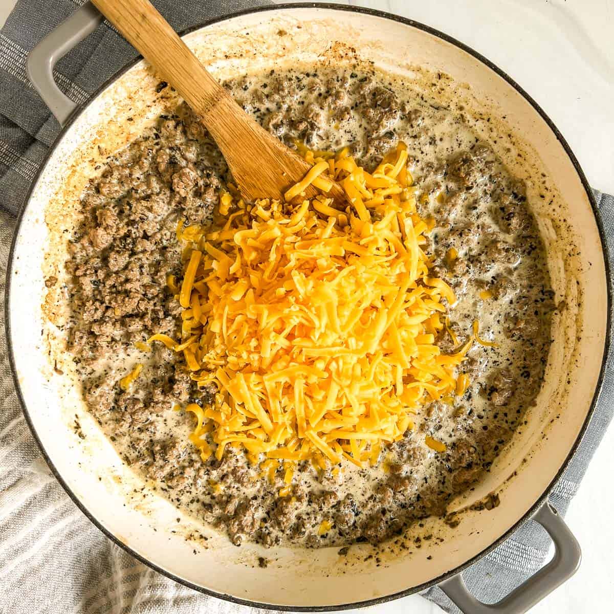 ground beef stroganoff recipe in a pan with cheese