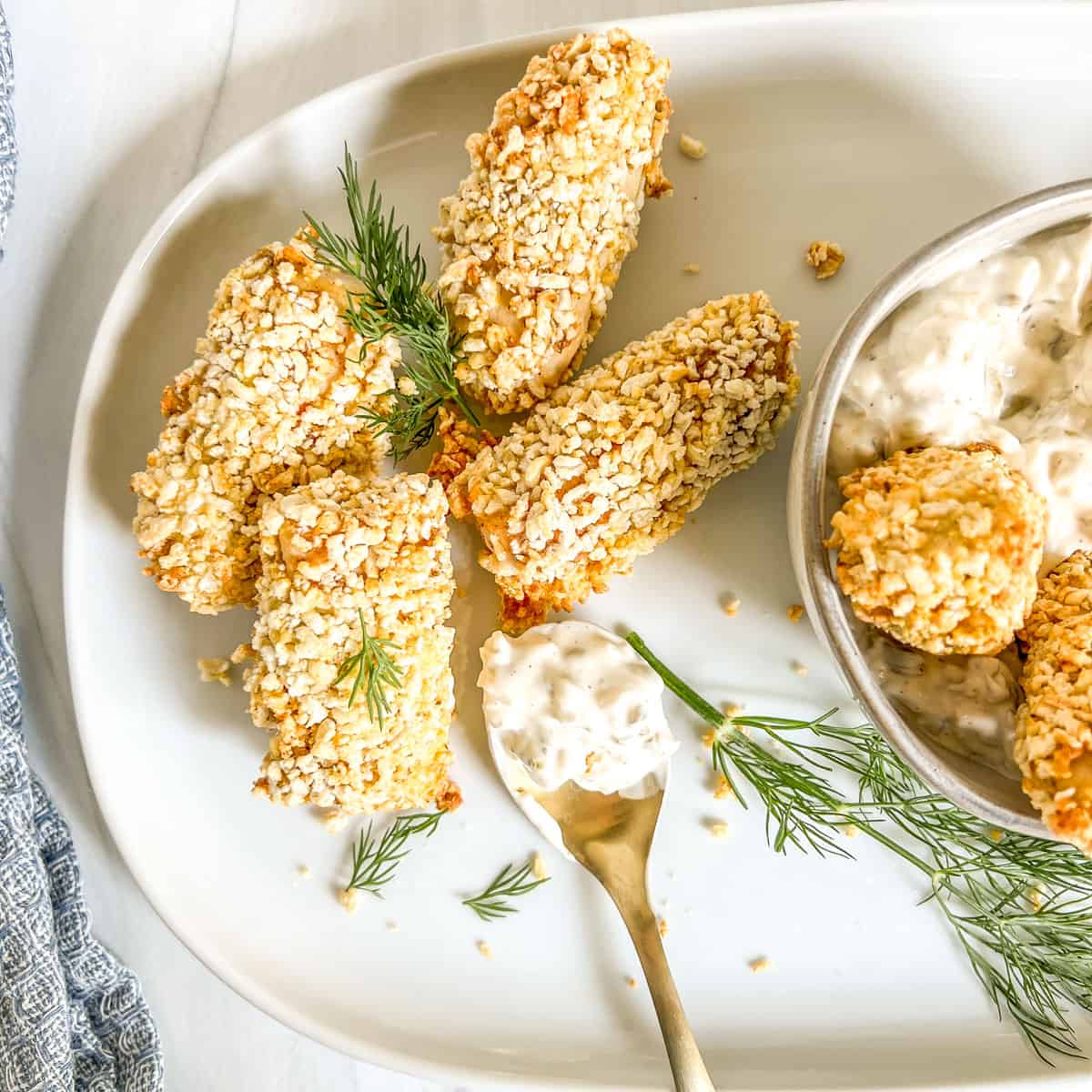 air fried fish sticks with spoon of tartar sauce