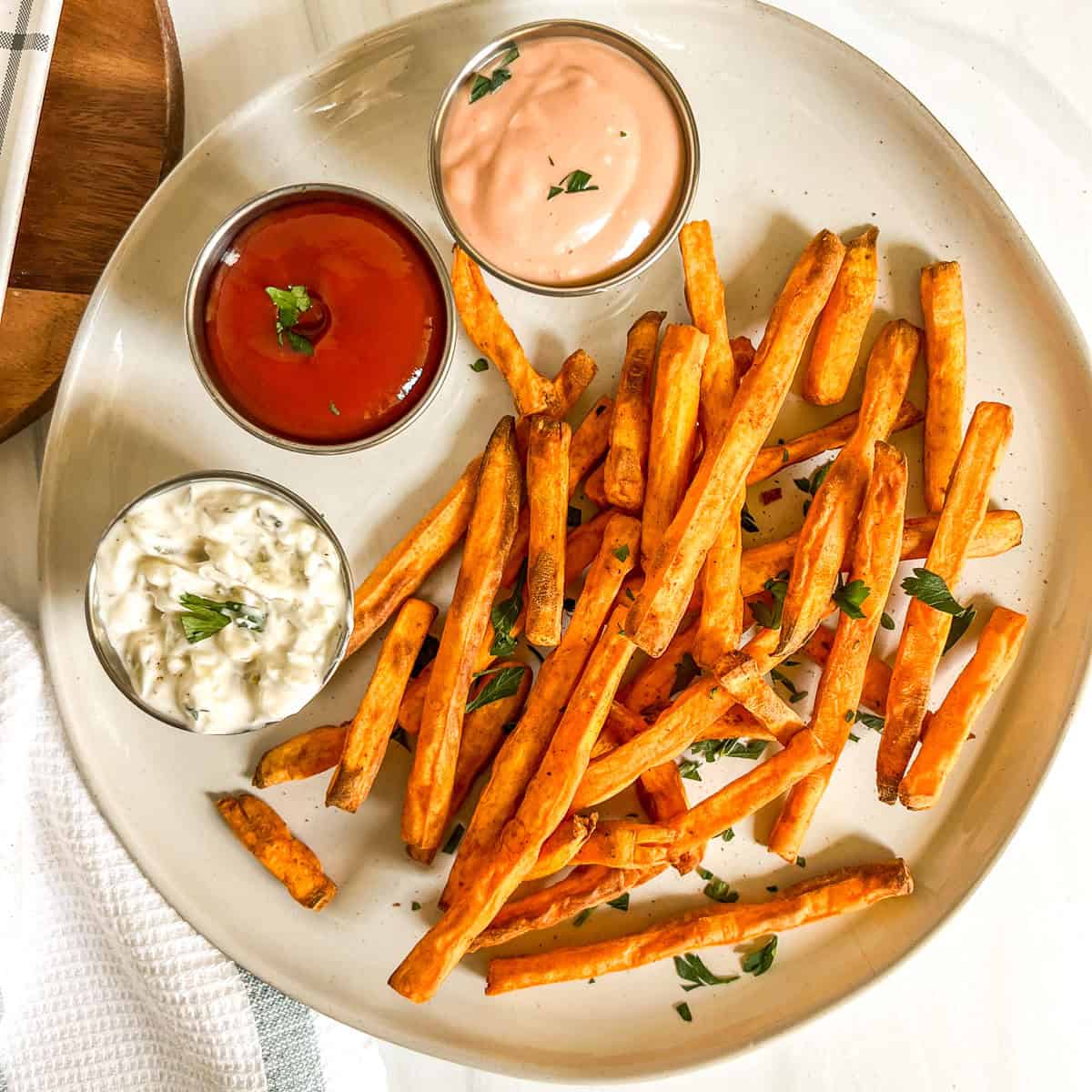 sweet potato fries on a plate with sauces