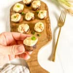 fingers holding stuffed mushroom