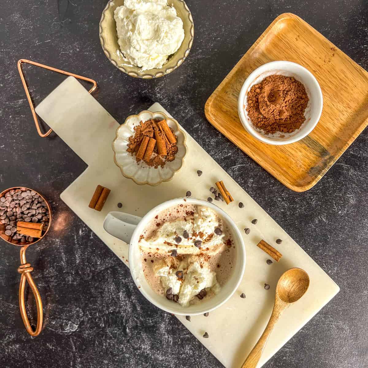 hot chocolate with whipping cream, cacao powder to the side