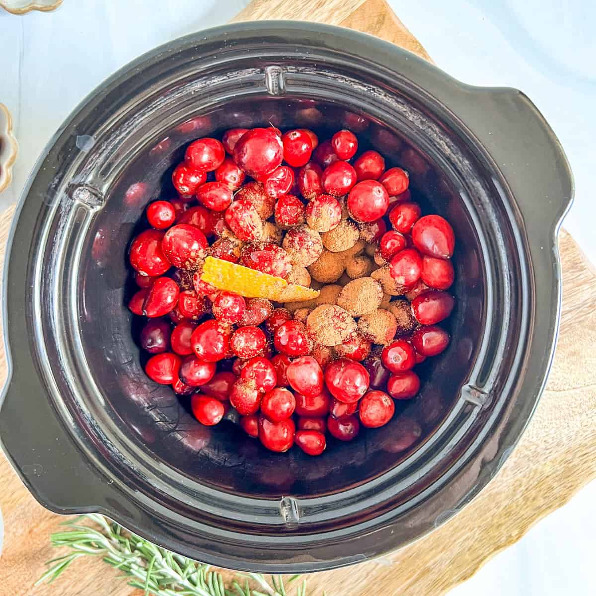 raw cranberries with cinnamon in a slow cooker