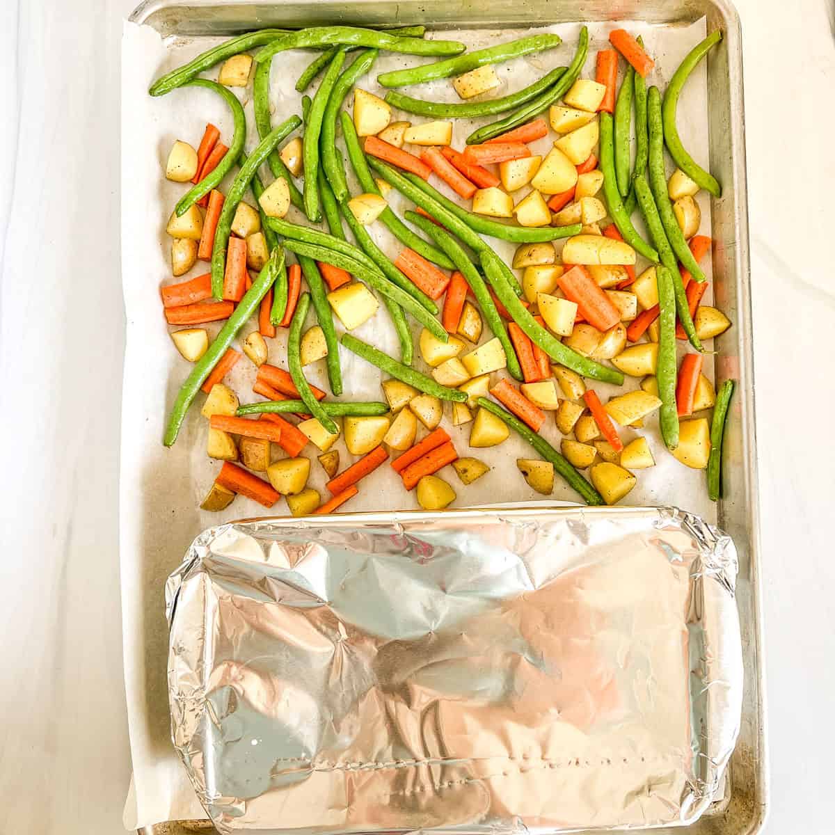 sheet pan of vegetables and a pan of chicken and rice