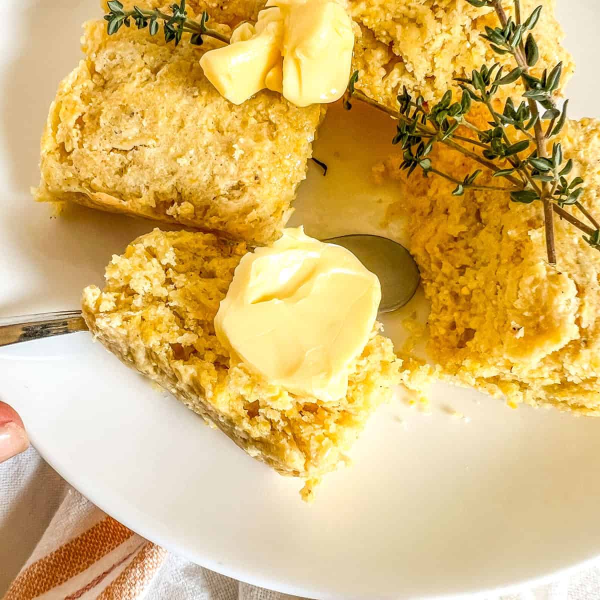 slice of cornbread with a dollop of butter on top