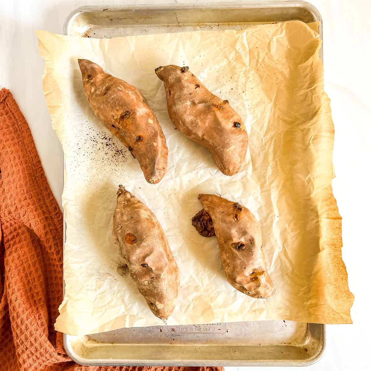 sweet potatoes baked on a baking sheet