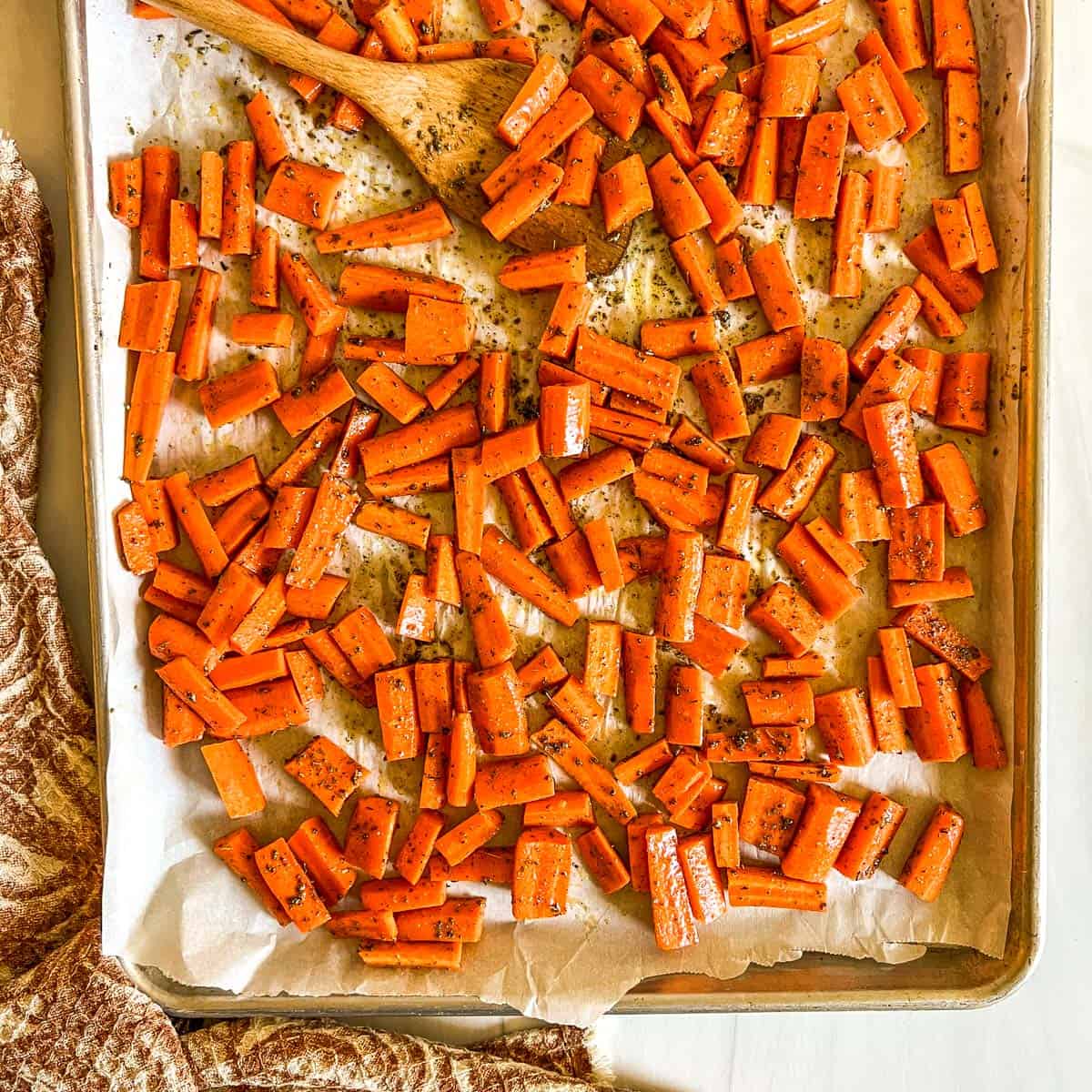 uncooked carrots on a baking sheet