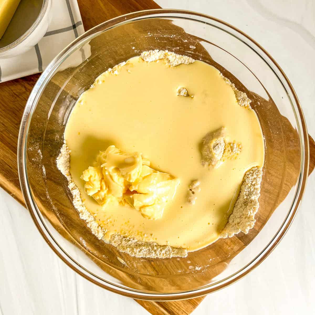 wet ingredients and dry ingredients together in a glass bowl