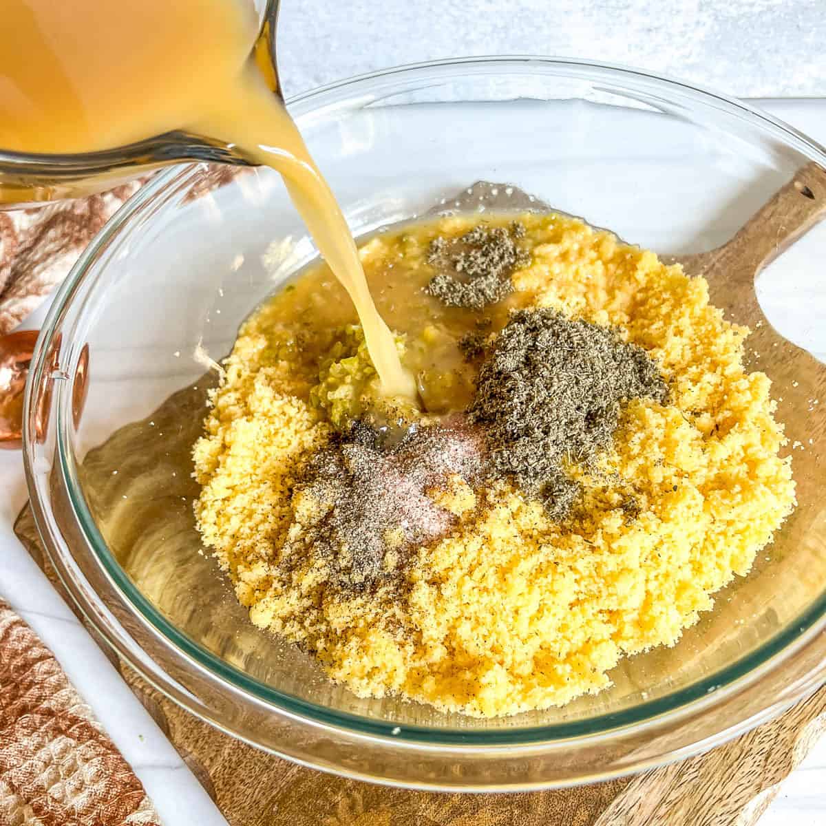broth poured in a bowl with cornbread dressing ingredients