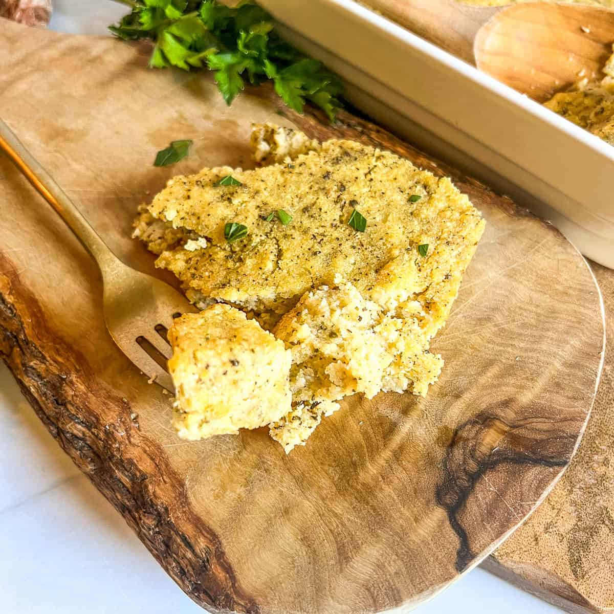 cornbread dressing on a gold fort on a wood platter