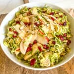 harvest salad mixed together in a large white bowl