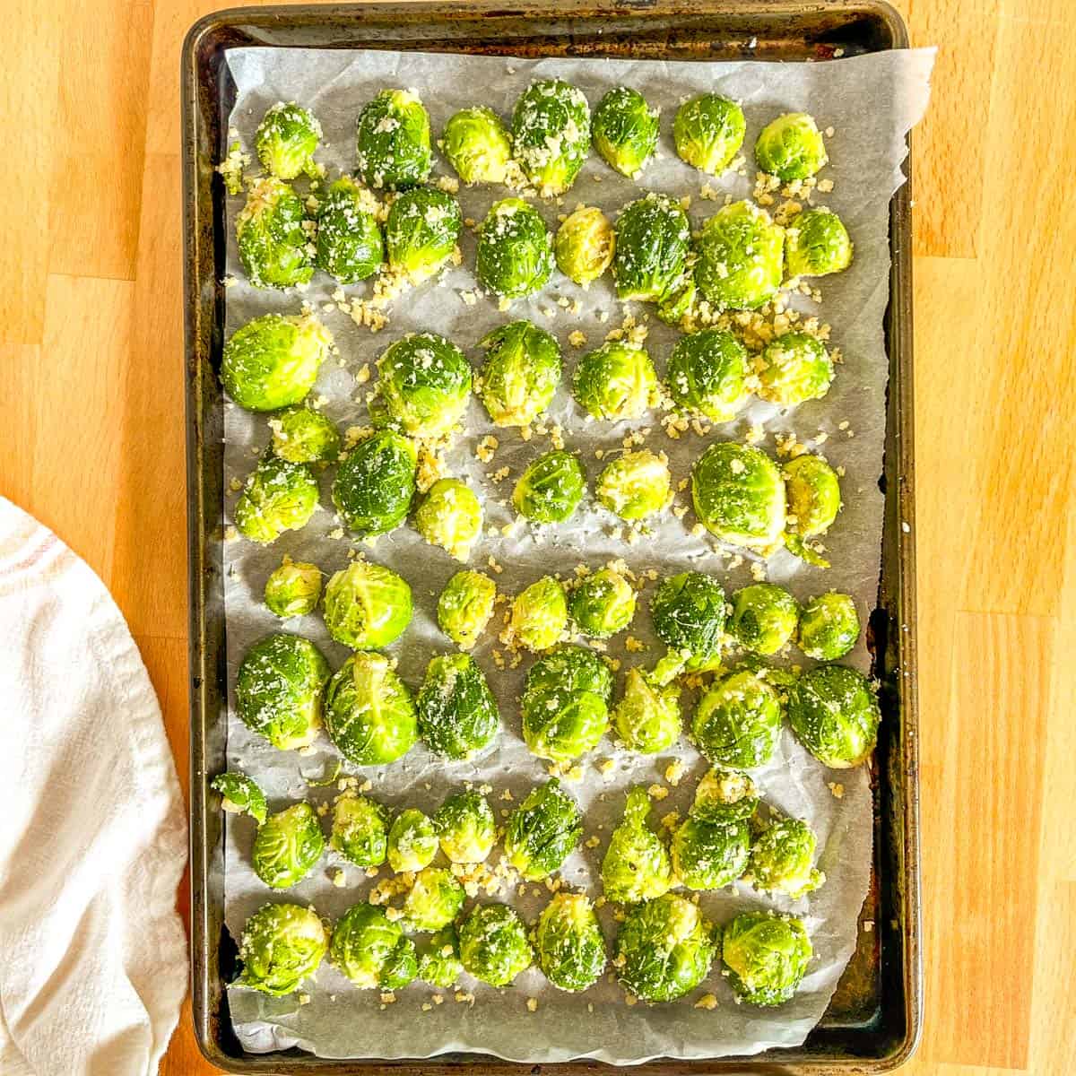 raw brussels sprout halves on a baking sheet