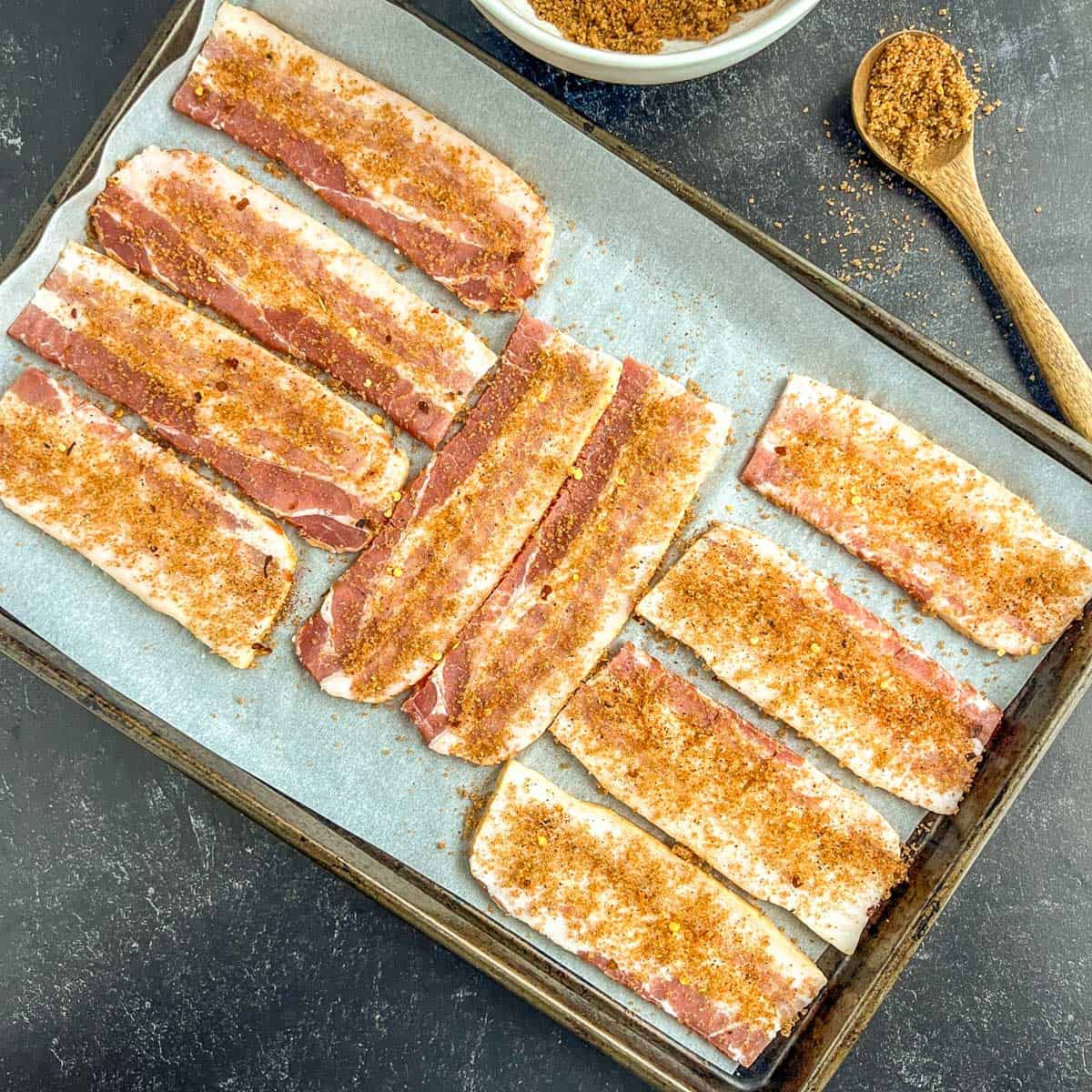 brown sugar and seasonings on pieces of bacon