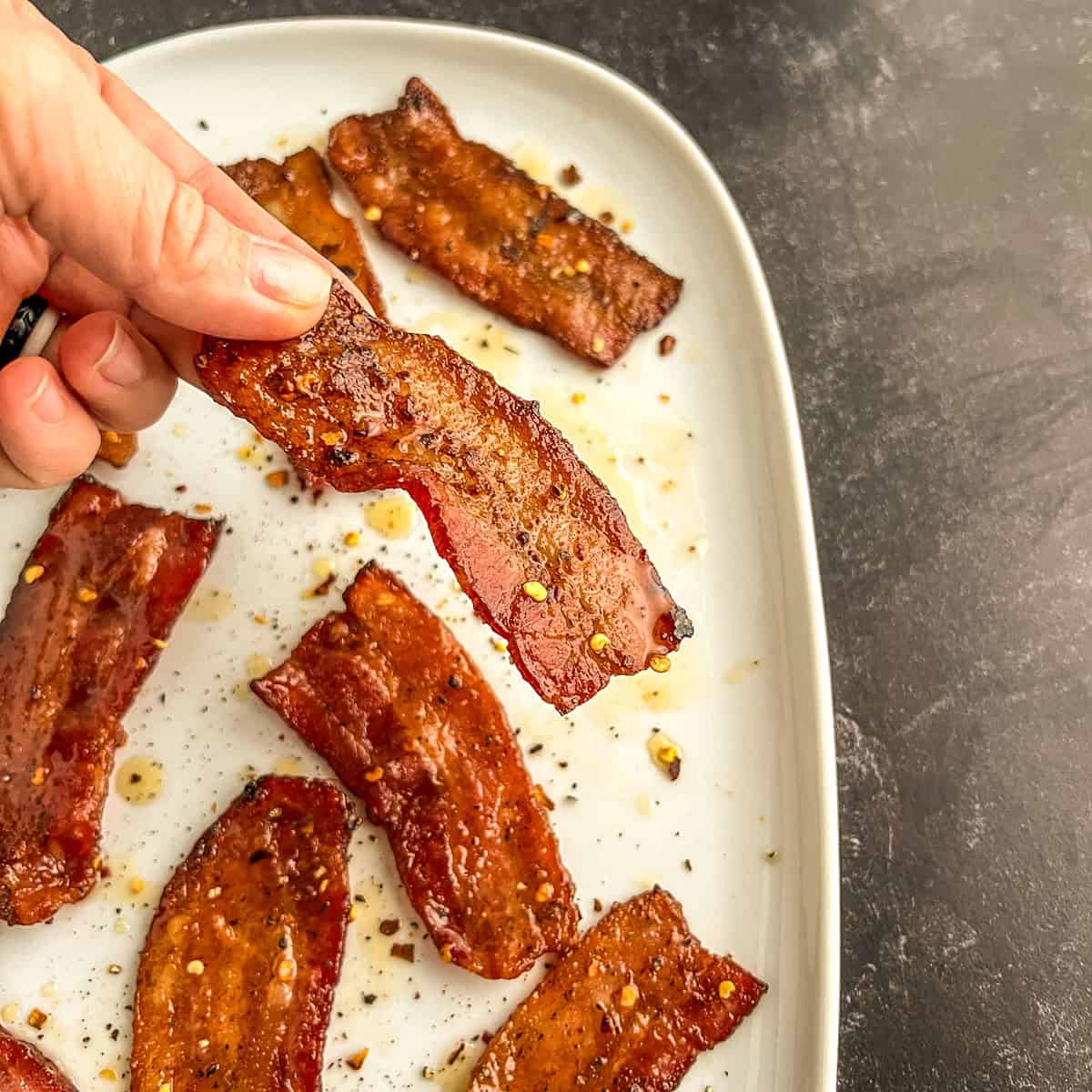 million dollar bacon in fingers