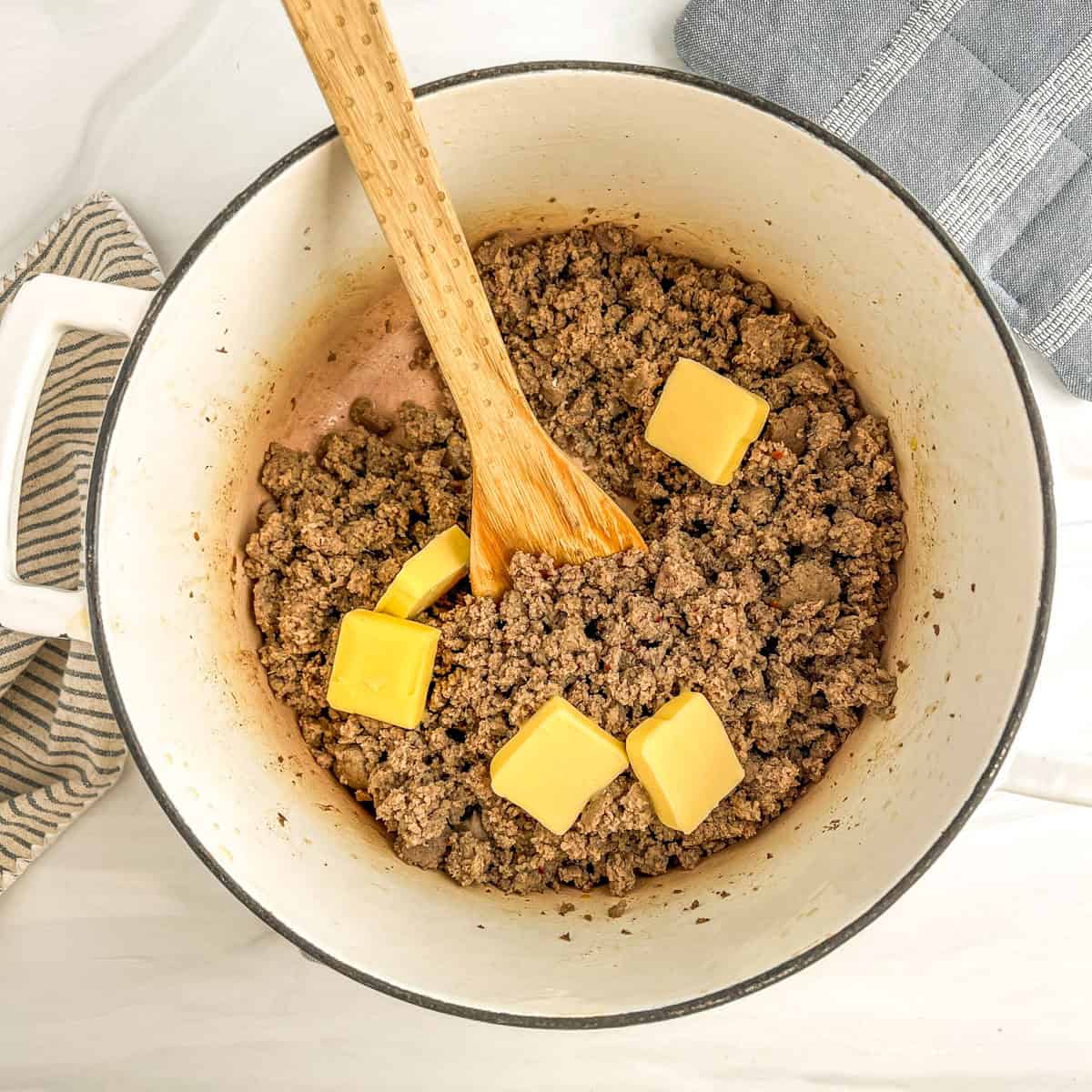 sausage in a large pot with butter