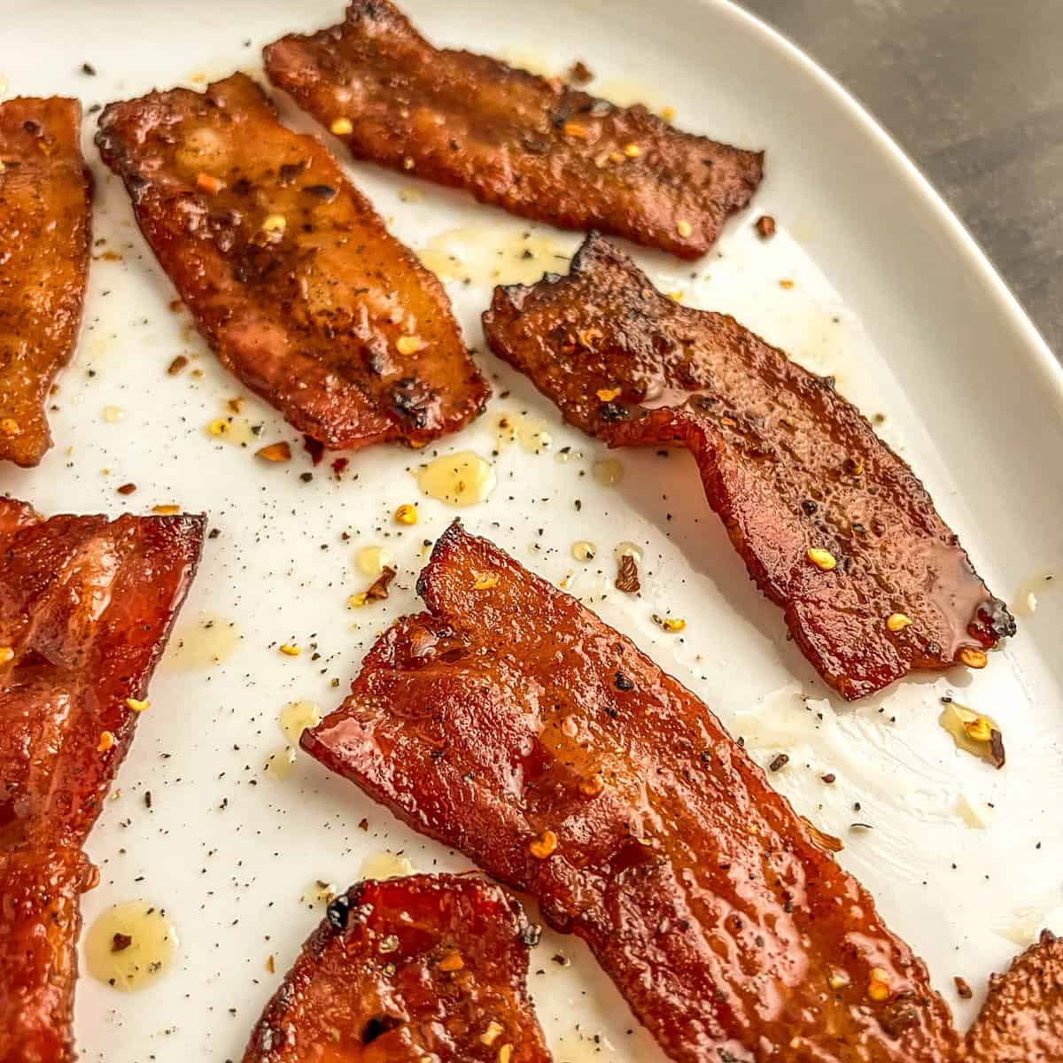 seasoned cooked bacon on a white plate