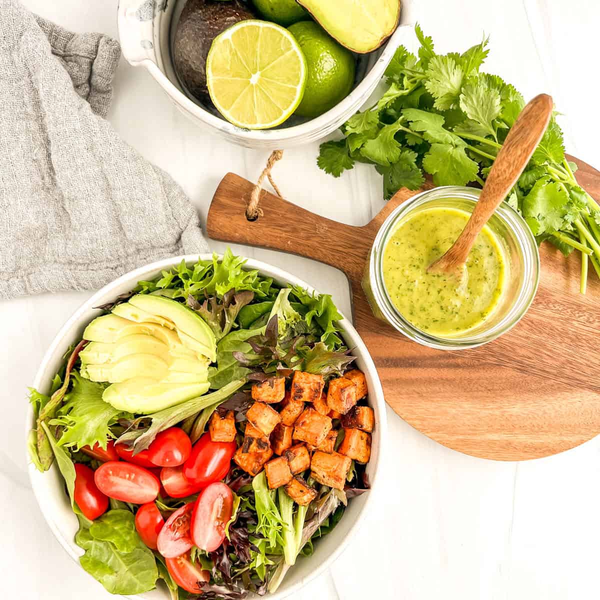 salad dressing and a salad to the side