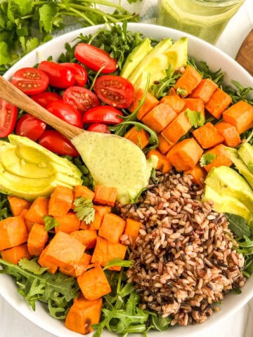 dressing on spoon in salad