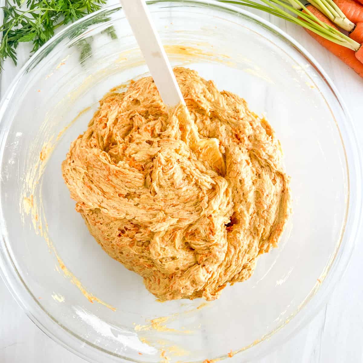 folded in shredded carrots in the batter