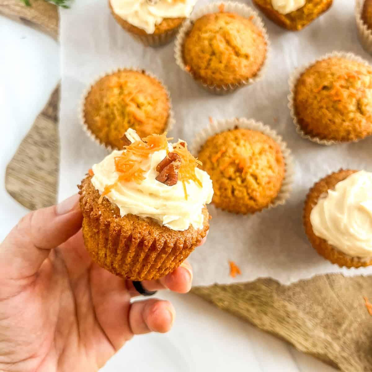 hand holding carrot cake muffins
