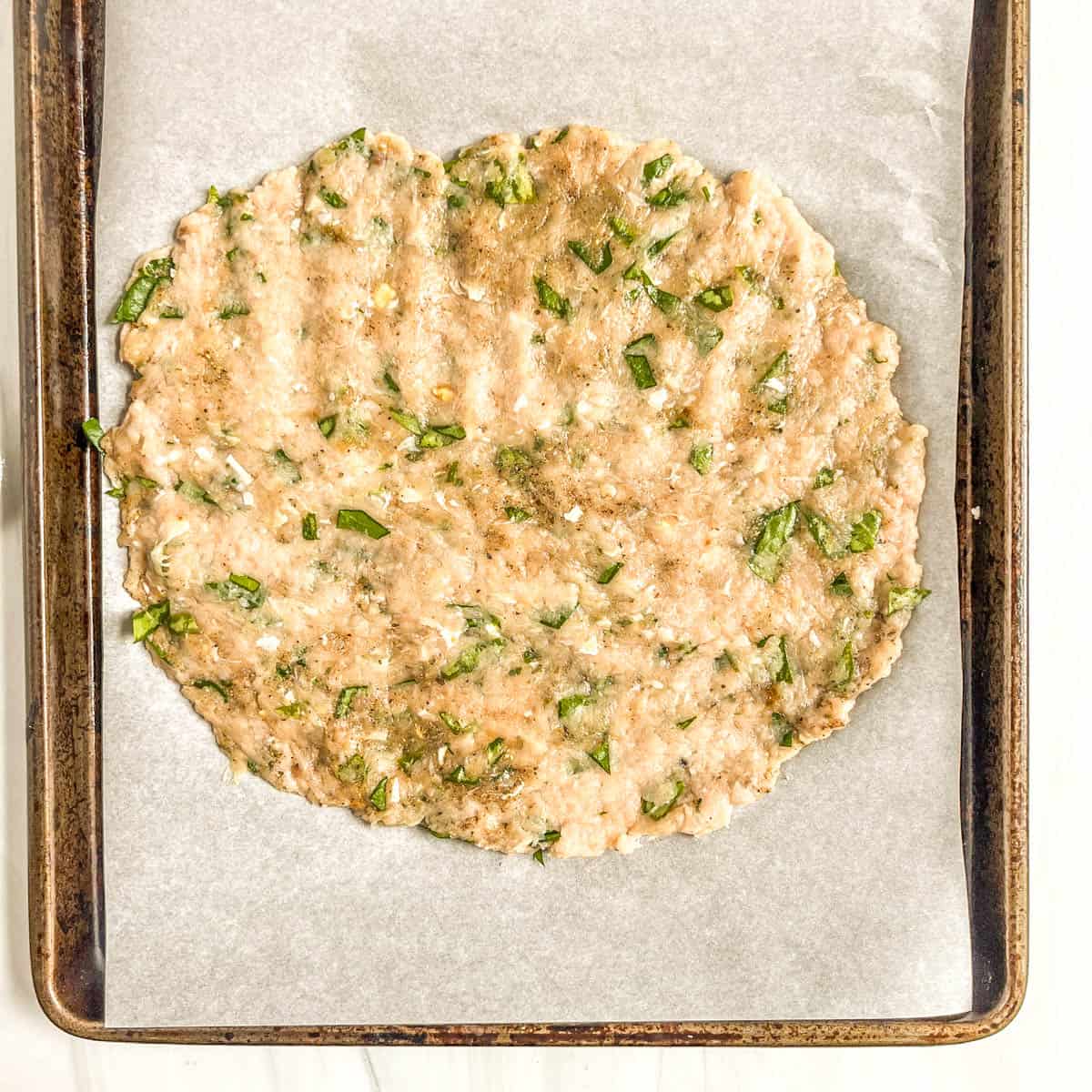 raw ground chicken on sheet pan
