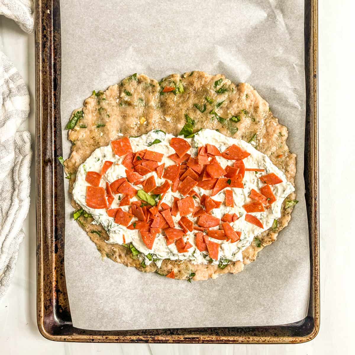 uncooked calzone with filling and chopped pepperoni