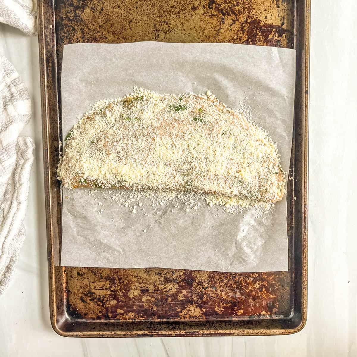 uncooked calzone with parmesan cheese on top